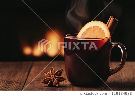Mulled wine, a warm drink with oranges and spices arranged on a soft green background, evoking a cozy winter concept 119184988