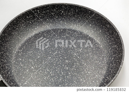 New frying pan closeup on white. New frying pan closeup on white. 119185832