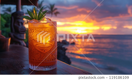 Mai Tai with a backdrop of Polynesian tiki statues and a Pacific island sunset. 119186109