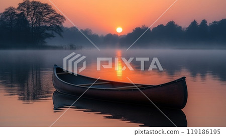 The peaceful solitude of a canoe on a misty lake at dawn 119186195