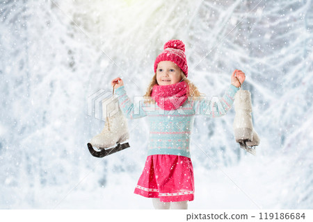 Little girl having fun at ice skating in winter Little girl having fun at ice skating in winter 119186684