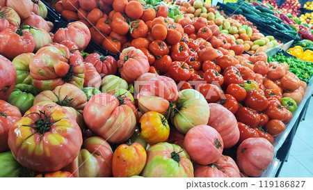 An assortment of exotic tropical vegetables such as sweet potato, ginger, eggplant, shusha, ginger tomatoes, cucumbers, at a food market on the island of Madeira in Portugal 119186827