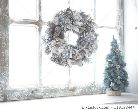 Christmas wreath and Christmas tree on the window sill Christmas wreath and Christmas tree on the window sill 119188444