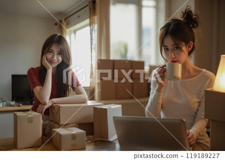 Two women are working from home to sell products online. 119189227
