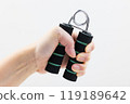 A woman's hand gripping a hand grip 119189642