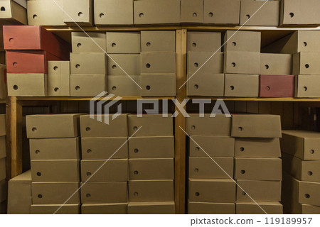 Efficient storage in a small shop filled with organized cardboard boxes Efficient storage in a small shop filled with organized cardboard boxes 119189957