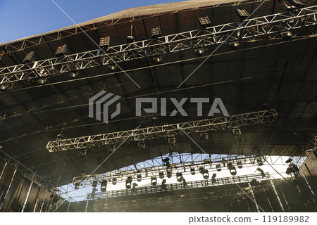 Design of spotlights hanging on the ceiling of the stage at a music festival Design of spotlights hanging on the ceiling of the stage at a music festival 119189982