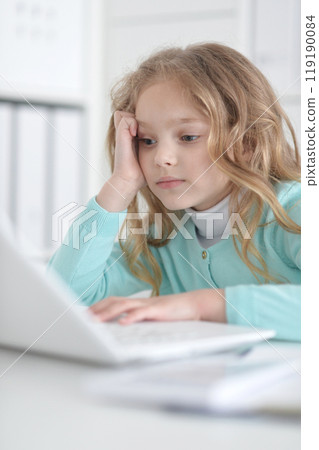 Cute and happy little girl children using laptop computer Cute and happy little girl children using laptop computer 119190084