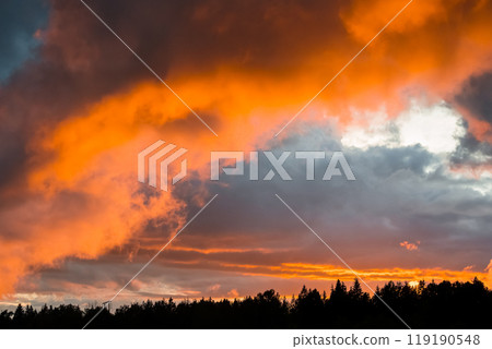 Fiery orange sunset and clouds Fiery orange sunset and clouds 119190548