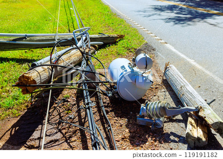 Strong winds of hurricane caused electric poles to crash down break their wires during storm 119191182