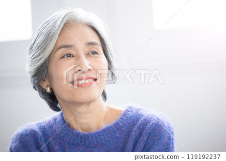 A beautiful gray-haired senior woman looking up - an image of vitality and health A beautiful gray-haired senior woman looking up - an image of vitality and health 119192237