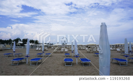 the sunbeds and parasols on the beach the sunbeds and parasols on the beach 119193268