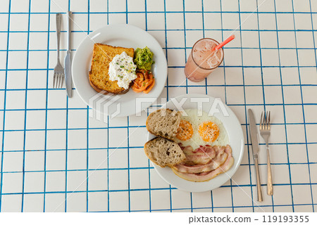 A vibrant and colorful breakfast plate featuring perfectly toasted bread with salmon, delicious eggs, and a refreshing lemonade 119193355