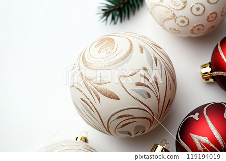 Beautiful Christmas ornaments with intricate red and white designs on white background. Concept of holiday decoration Beautiful Christmas ornaments with intricate red and white designs on white background. Concept of holiday decoration 119194019