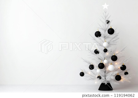 Modern Christmas tree features black and white ornaments, with wrapped gifts beneath it in a bright, minimalist space Modern Christmas tree features black and white ornaments, with wrapped gifts beneath it in a bright, minimalist space 119194062