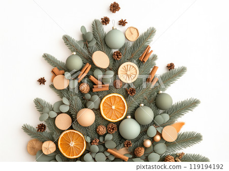 Creative composition of ornaments, pinecones and dried fruits on green branches, ideal for Christmas holiday decorations 119194192