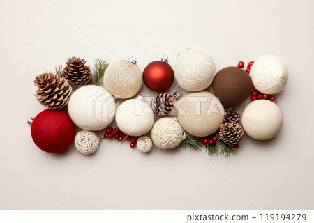 Christmas ornaments and pine cones arranged aesthetically on a white background. Holiday decor concept Christmas ornaments and pine cones arranged aesthetically on a white background. Holiday decor concept 119194279