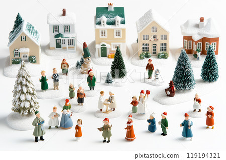Miniature winter village with various houses, trees, and figurines on a white snowy background. Festive holiday decor 119194321