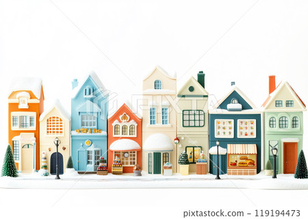 Miniature winter village with various houses, trees, and figurines on a white snowy background. Festive holiday decor 119194473
