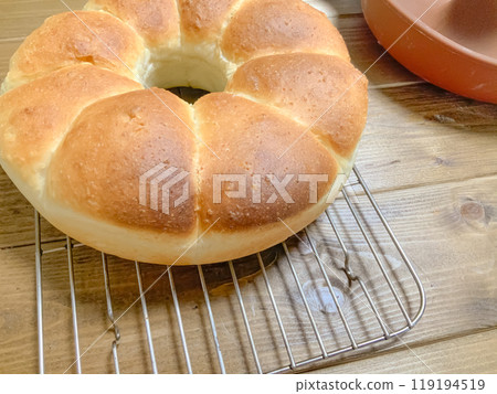 Freshly baked round bread cooling on a wire rack Freshly baked round bread cooling on a wire rack 119194519