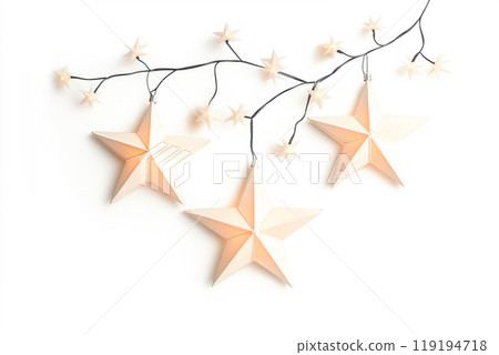 Decorative white Christmas stars with golden accents and fairy lights on white background. Festive holiday decor concept 119194718