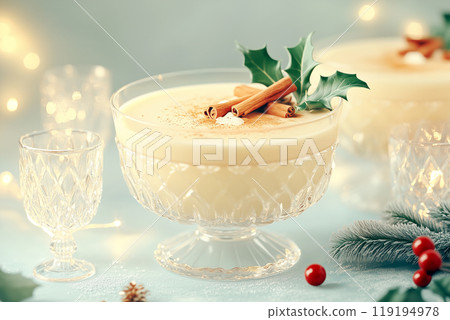 A close-up of eggnog garnished with cinnamon and holly, set on a soft background, evoking a festive Christmas atmosphere 119194978