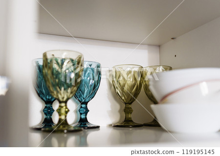 Clean dishes and tableware on white shelf 119195145