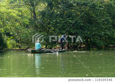 People clean the river inTrang An, Vietnam. People clean the river inTrang An, Vietnam. 119195548