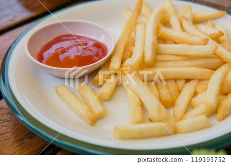 french fries on plate with tomato sauce 119195752