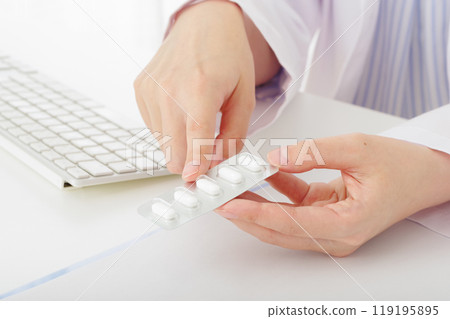 A woman in a white coat explaining prescription drugs (no face) A woman in a white coat explaining prescription drugs (no face) 119195895