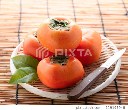 Taste of Autumn: Persimmons arranged in a colander Taste of Autumn: Persimmons arranged in a colander 119195946