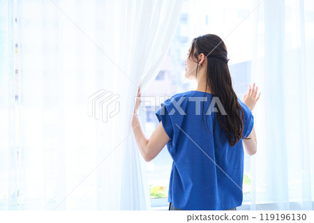 Woman looking at the view outside Woman looking at the view outside 119196130