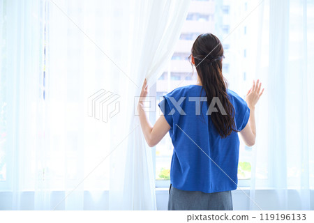 Woman looking at the view outside 119196133