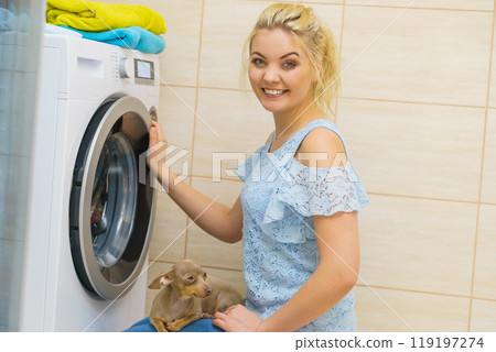 Woman setting washing machine Woman setting washing machine 119197274