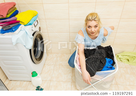 Woman about to do laundry 119197291