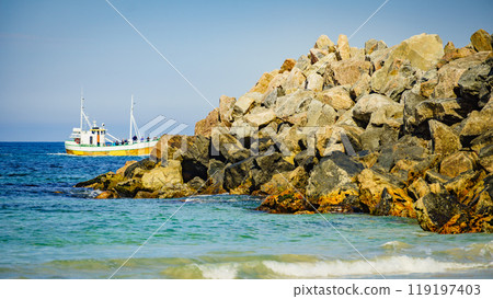 Seascape with fishing boat and stone breakwater Seascape with fishing boat and stone breakwater 119197403