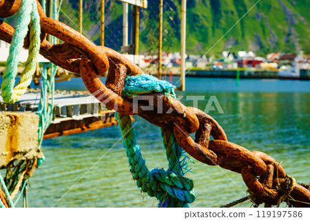 Rusty old metal chain links in port. Rusty old metal chain links in port. 119197586