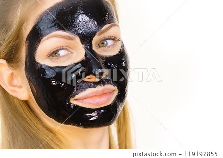 Woman with black peel off mask on face 119197855