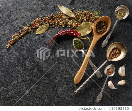 Mix of organic dried spices on a black stone background. 119198310