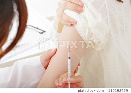 A woman getting an injection in her arm 119198459
