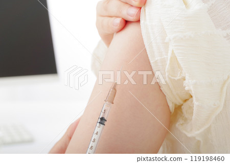 A woman getting an injection in her arm 119198460