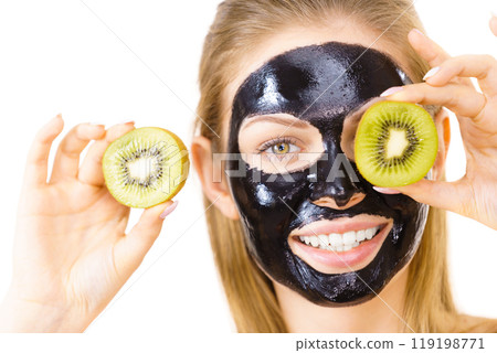 Girl black mask on face holds kiwi fruit 119198771