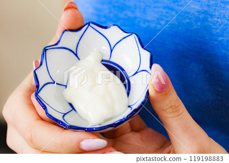 Girl holds bowl with cream cosmetic Girl holds bowl with cream cosmetic 119198883