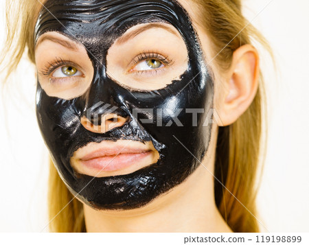 Girl black carbo peel off mask on face 119198899