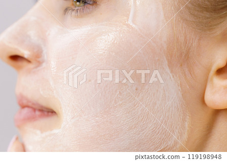 Girl with cream moisture cosmetic on face 119198948