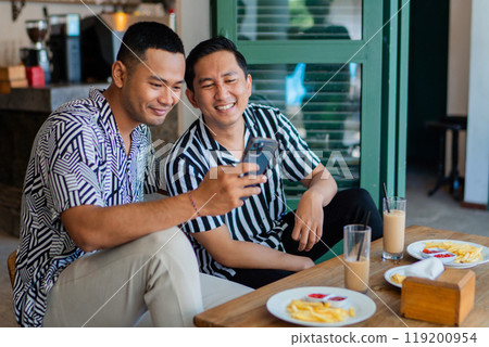 A Group of Friends Lovingly Enjoying Breakfast and Sharing Joyful Moments Together 119200954