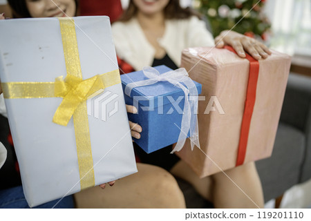 cropped hand holding christmas present box cropped hand holding christmas present box 119201110