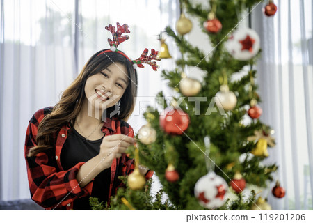asian girl decorating christmas tree ornament asian girl decorating christmas tree ornament 119201206