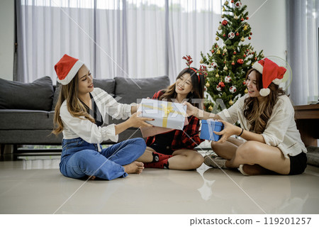 group young girls giving christmas present 119201257