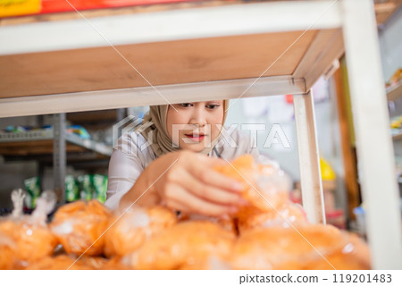 A woman is shopping for fresh produce in a vibrant local market filled with colors A woman is shopping for fresh produce in a vibrant local market filled with colors 119201483